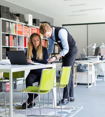 portrait-of-woman-with-male-colleague-working-in-o-WNVJ4CS-1.jpg