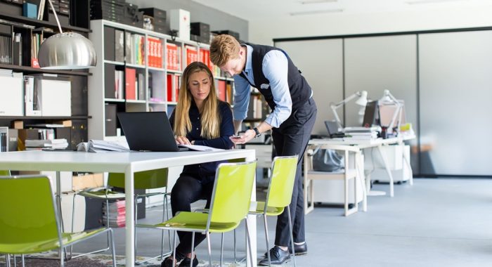 portrait-of-woman-with-male-colleague-working-in-o-WNVJ4CS-1.jpg